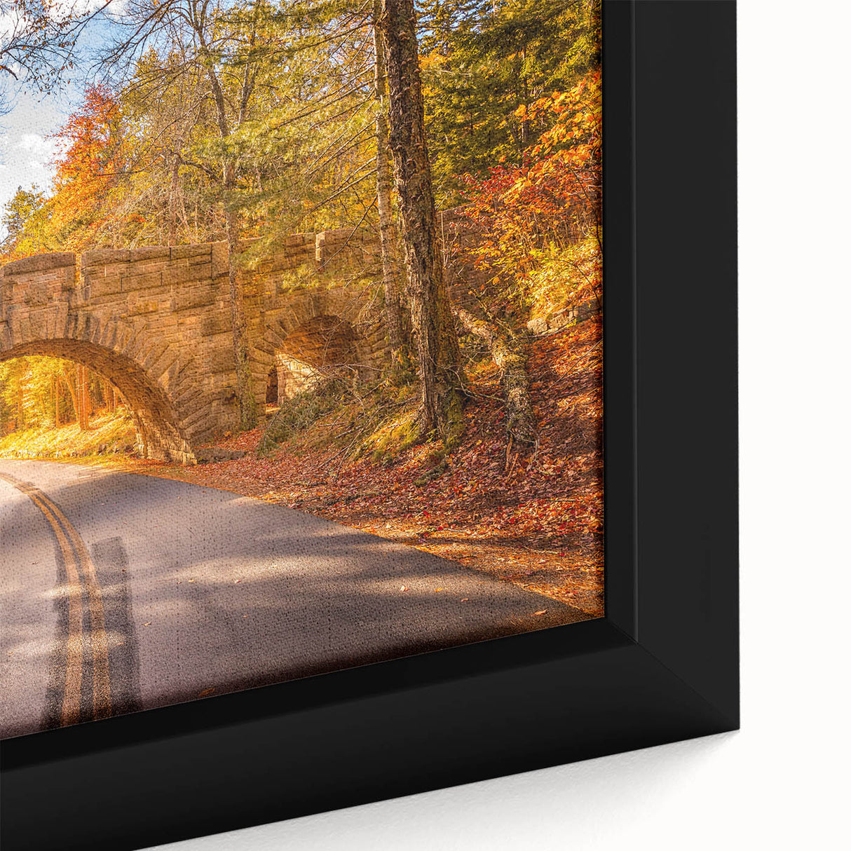 Close-up of a black framed canvas featuring a textured depiction of Acadia, Maine with colorful art accents.