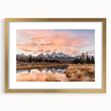 Extra large wall art of the Grand Tetons under a clear sky, presented in a gold frame with mat, ideal for living room decor.