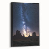 Framed canvas artwork depicting a vibrant desert landscape, showcasing warm tones of orange and yellow with a black frame, perfect for modern home decor.