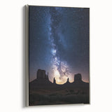 Framed canvas artwork depicting a stunning desert landscape with vibrant colors and intricate details, showcased from a side view with a sleek silver frame.