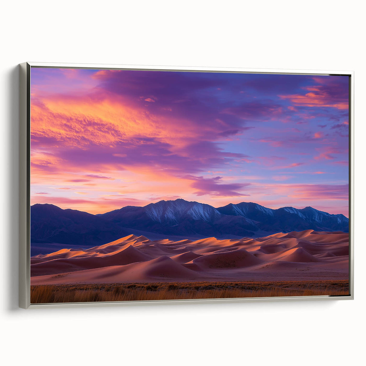 Framed canvas artwork displaying serene dune landscapes in soft beige and gray tones, with a sleek silver frame, perfect for modern home decor.