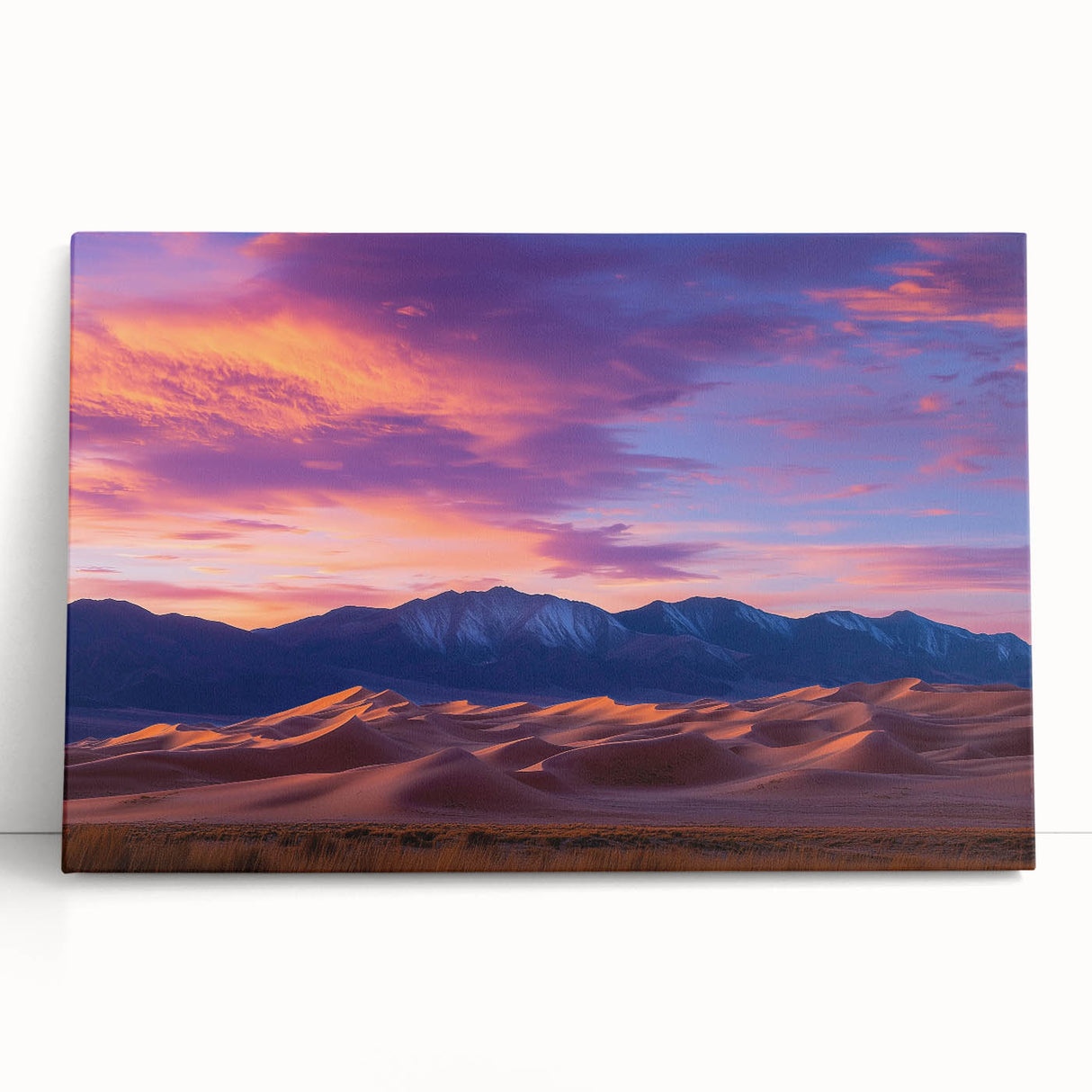 Stretched canvas artwork depicting serene sand dunes under a vibrant sunset, showcasing warm golden and orange hues, perfect for enhancing home decor.