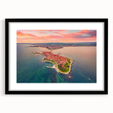 Colorful abstract art print of a European scenery in vibrant hues on a black framed canvas, ideal for living room decor.