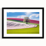 Colorful abstract art print of a European scenery in vibrant hues, on a large textured canvas with a black frame.