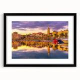 Extra large, textured abstract art print of a colorful European scenery, framed in black, ideal for living room decor.