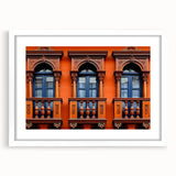 Abstract art print depicting a stylized Saudi Arabian landscape in muted earth tones, framed with a white mat.