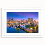 Abstract art print of San Diego skyline in muted blue and gray tones on a framed white mat, ideal for dining room decor.