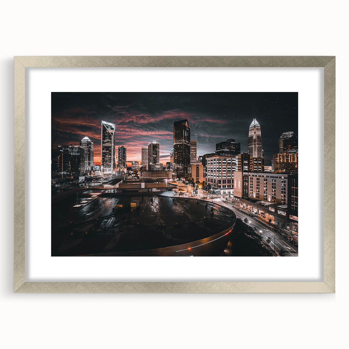 Textured art depicting an abstract Charlotte skyline in muted blues and grays on a framed silver mat.