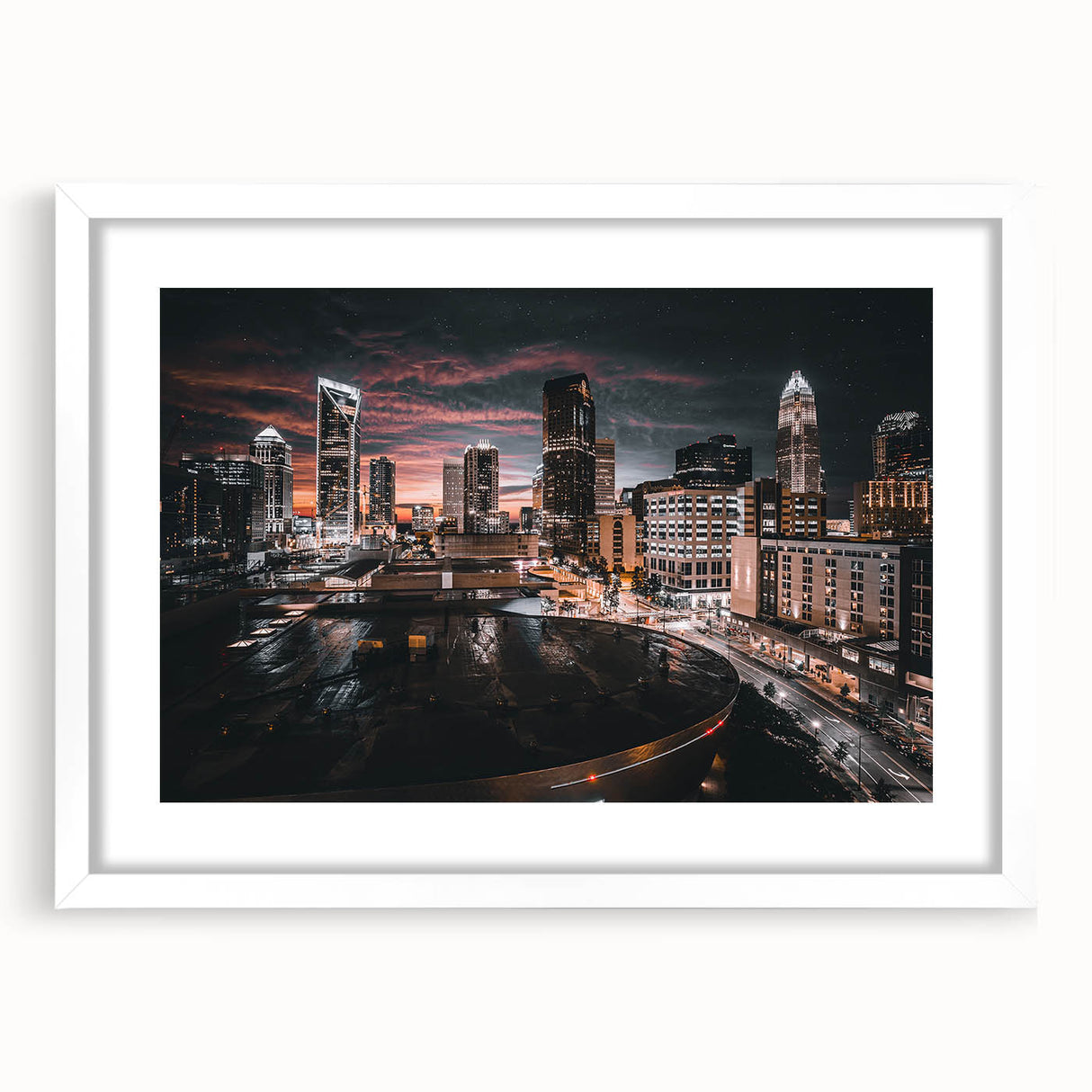 Abstract art print of Charlotte skyline in muted blue and gray tones on a framed white mat, ideal for dining room decor.