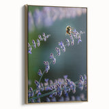 Framed canvas featuring a vintage landscape painting with spring theme in muted green and gold tones.