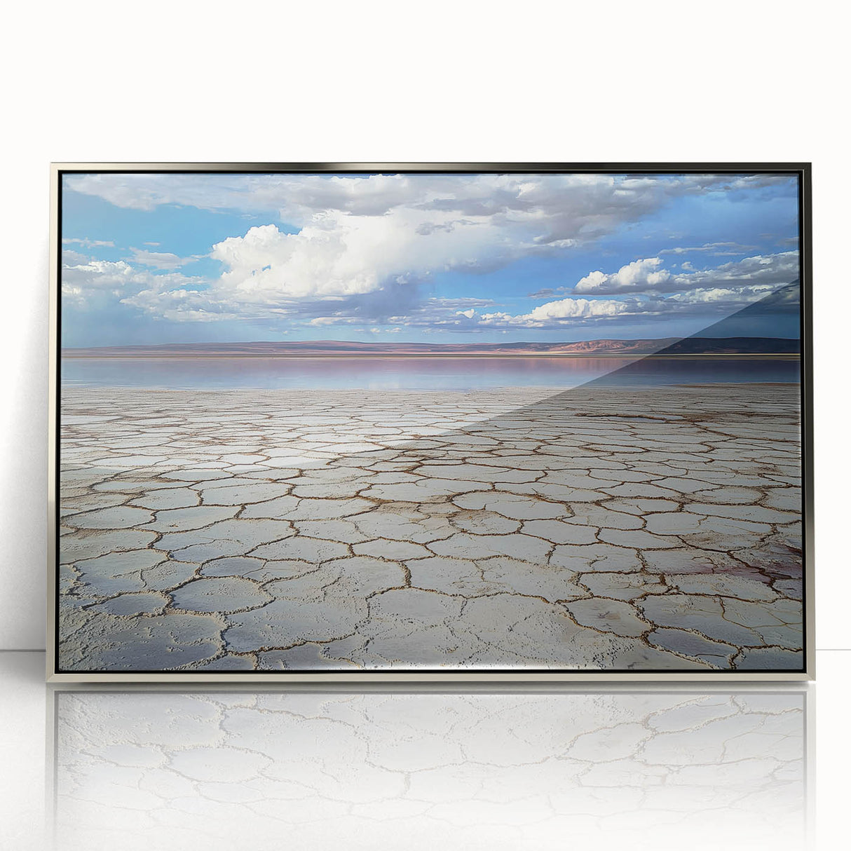 Framed acrylic artwork depicting an abstract landscape in silver tones, showcasing fluid shapes and textures, perfect for modern home decor and art enthusiasts.