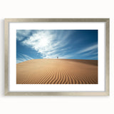 Framed landscape artwork depicting a serene desert scene, featuring a silver mat and sleek frame, perfect for enhancing home decor with a modern touch.