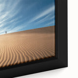 Close-up of a framed canvas print showcasing a vibrant desert landscape, featuring rich hues of orange and yellow, ideal for home decor and wall art enthusiasts.