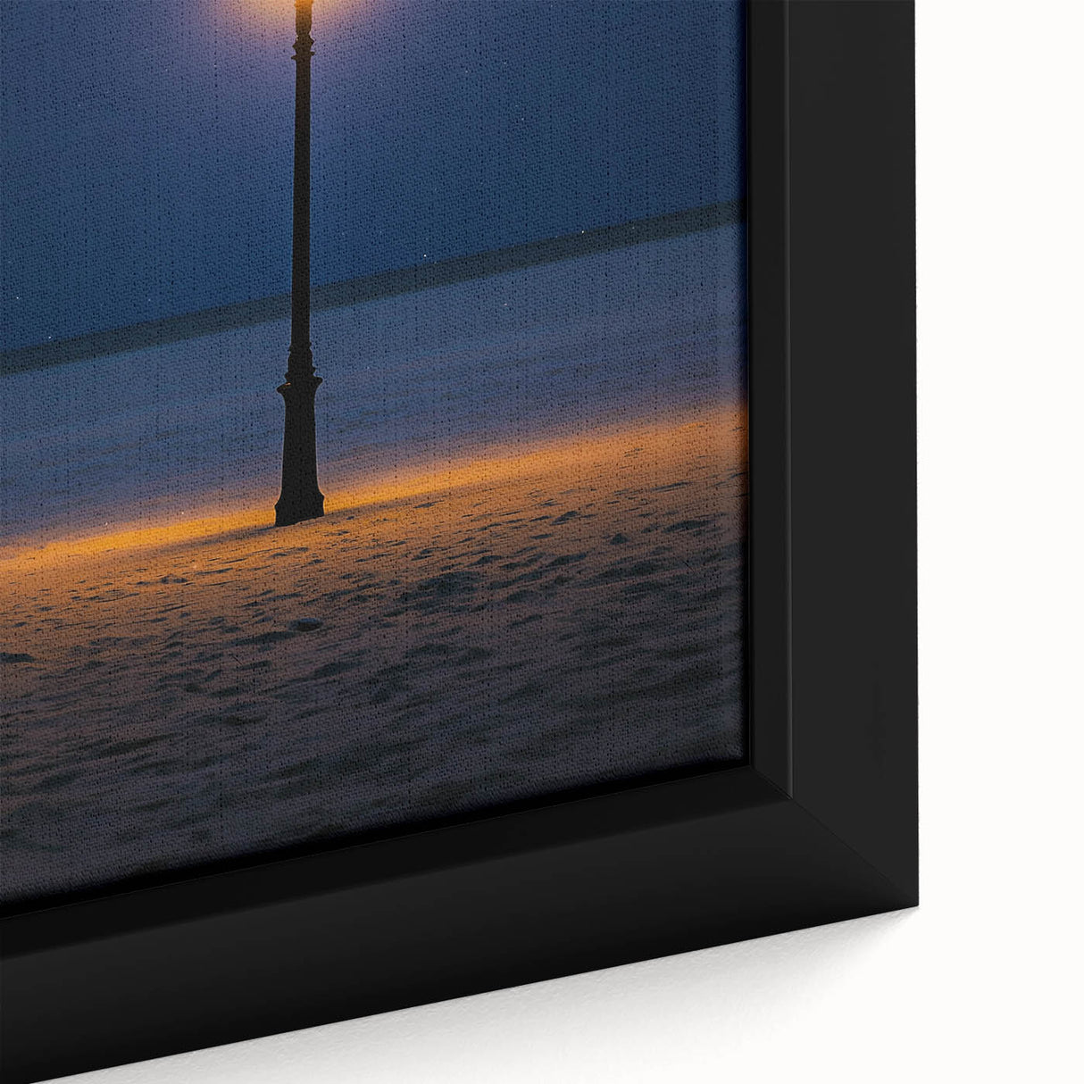 Close-up of a framed canvas depicting serene sand dunes at sunset, showcasing soft golden and orange hues, perfect for enhancing modern home decor.