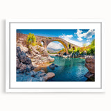 Textured abstract art print of a European scenery in muted earth tones, framed with a white mat, suitable for bedroom decor.