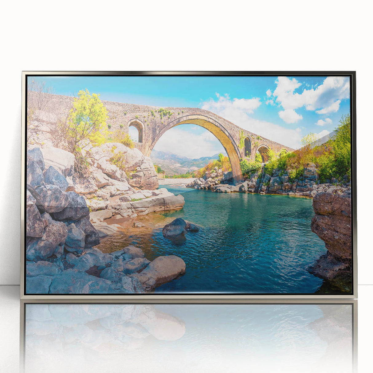 Large art print of a European Albanian landscape in muted earth tones on a silver-framed acrylic.