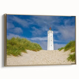 Framed canvas featuring a vintage-style landscape painting of a European scenery in muted gold and black tones.