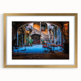 Abstract art print of Barcelona scenery in muted gold and blue tones on a framed canvas, suitable for dining room decor.