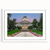 Abstract art print of a Maine landscape in muted green and blue tones on a white framed canvas.