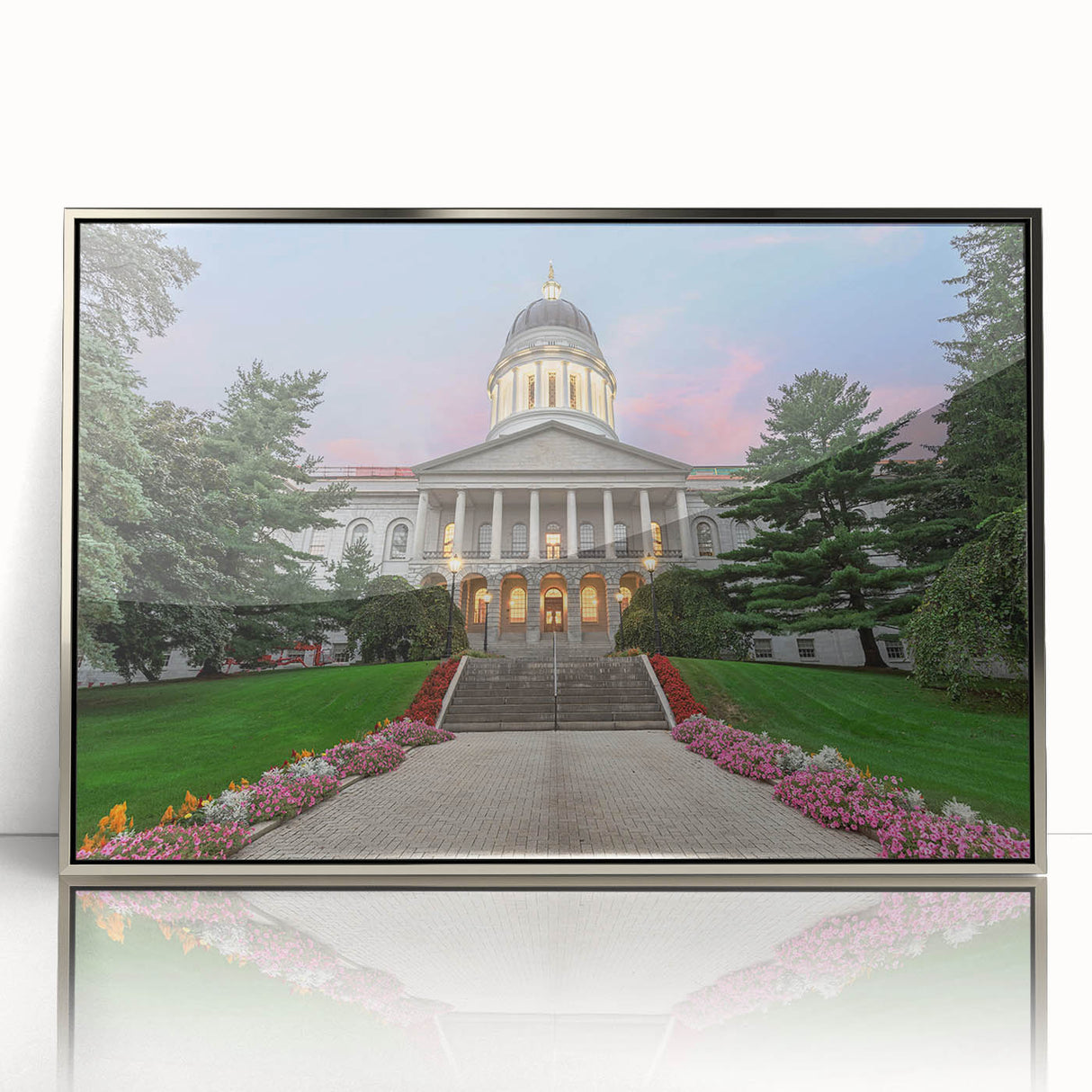 Mid-century modernist art depicting a serene Maine landscape in soft blue and green hues, framed in silver acrylic.