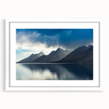 Abstract art print of the Grand Tetons with muted earth tones on a framed white mat, ideal for dining room decor.