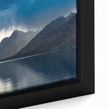Black wall art featuring a textured depiction of the Grand Tetons under a colorful sky on a framed canvas.