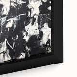 Framed canvas close-up displaying vibrant abstract splatters in shades of blue, orange, and yellow, perfect for modern home decor or artistic spaces.