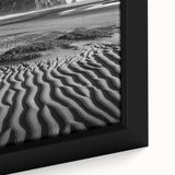 Close-up of a framed canvas artwork depicting vibrant desert dunes at sunset, showcasing rich hues of orange and gold, perfect for home decor in modern aesthetics.