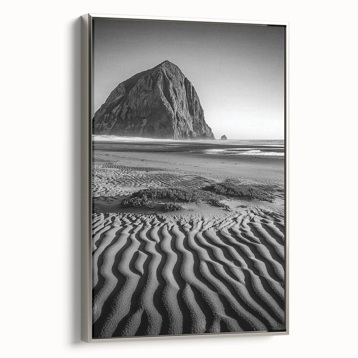 Framed canvas artwork depicting serene sand dunes in soft beige and gold tones, with a sleek silver frame, adding elegance to modern decor. Perfect for enhancing minimalist interiors.