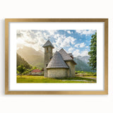 Abstract art print of a European Albanian scenery in muted earth tones, framed in gold.