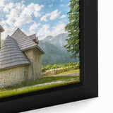 Black wall art featuring a textured, colorful European scenery on a framed canvas, ideal for living room decor.