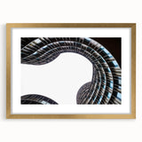 Abstract art print of a European scenery in muted blue and green tones on a framed canvas.