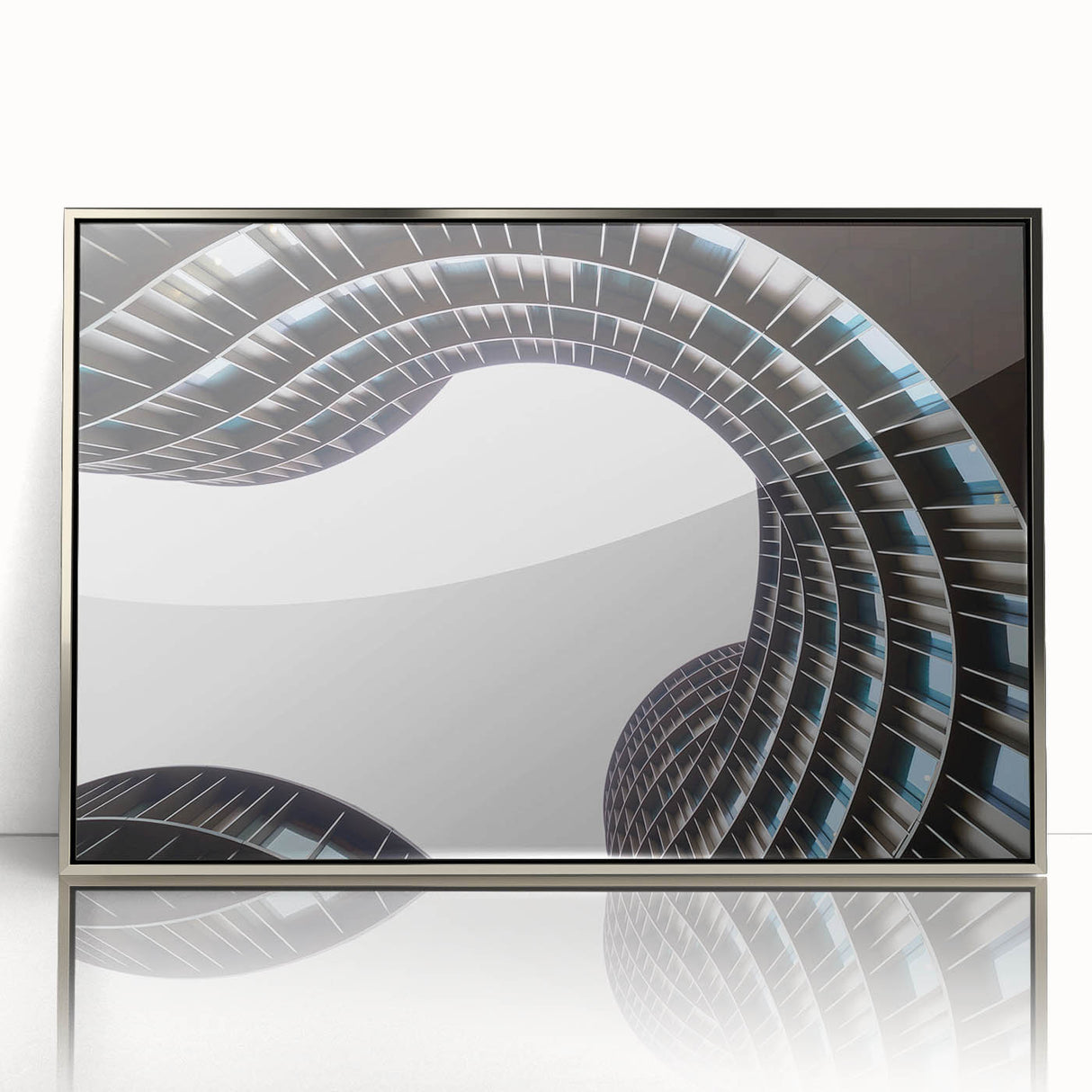Large art print of a serene Danish landscape in muted green and blue tones, framed in silver acrylic.