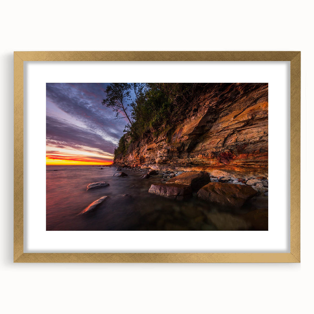 Abstract art print of a Finnish landscape in muted gold and green tones on a framed canvas, suitable for dining room decor.