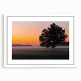 Textured art print depicting an abstract European landscape in muted earth tones, framed in white.