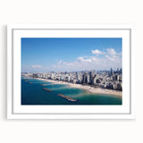Abstract art print of Tel Aviv skyline in muted blue and beige tones on a framed white mat, ideal for dining room decor.
