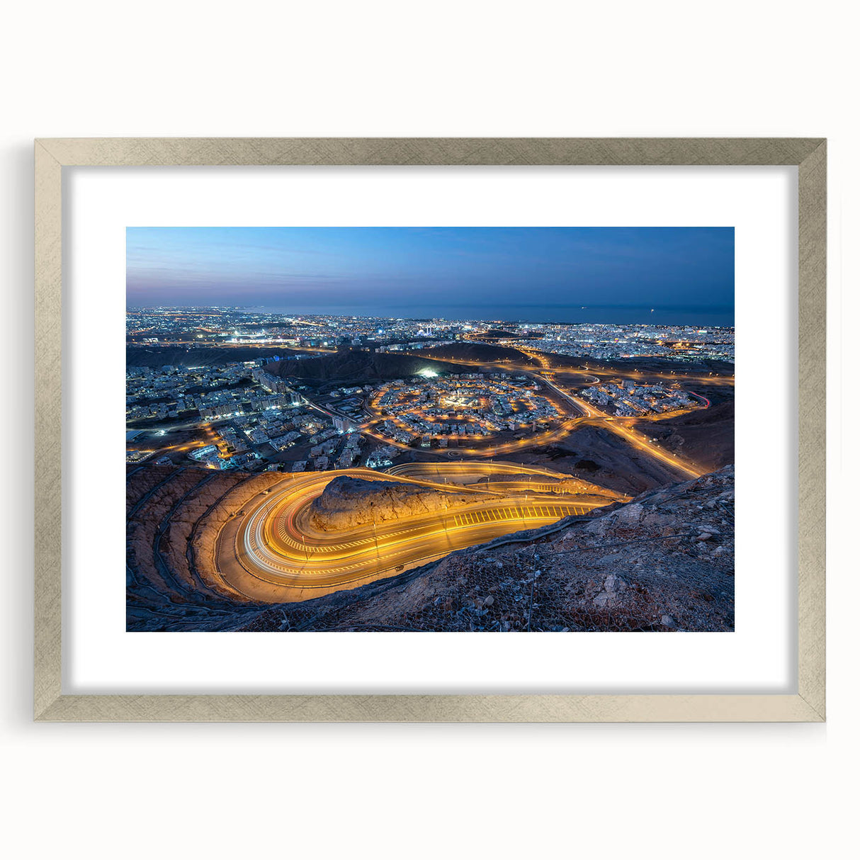 Textured art print depicting abstract scenery of Oman in muted earth tones, framed in silver, ideal for bedroom art.