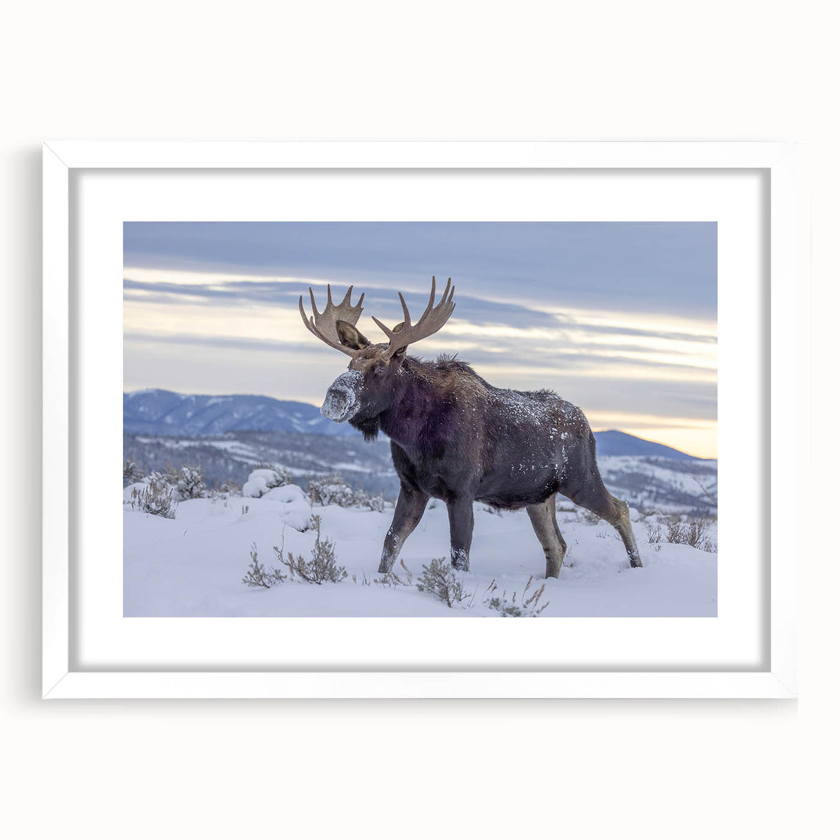 Abstract art print of the Grand Tetons in muted earth tones on a framed white mat, suitable for bedroom or dining room decor.