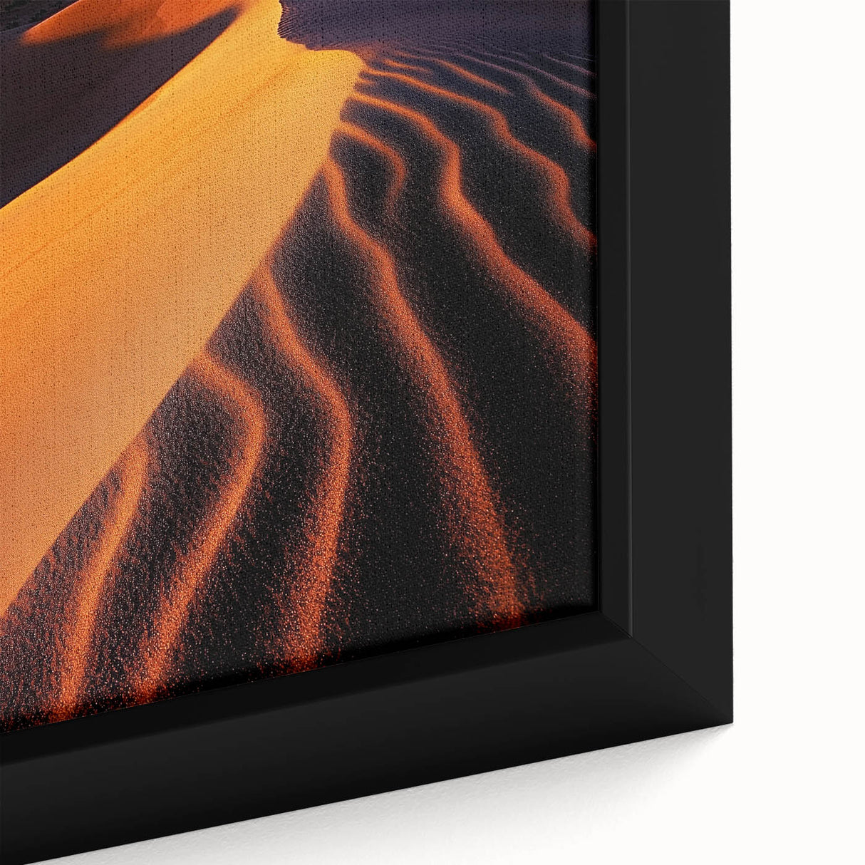 Close-up of a framed canvas artwork depicting serene sand dunes under a dramatic sky, showcasing warm beige and golden tones, ideal for enhancing modern decor.