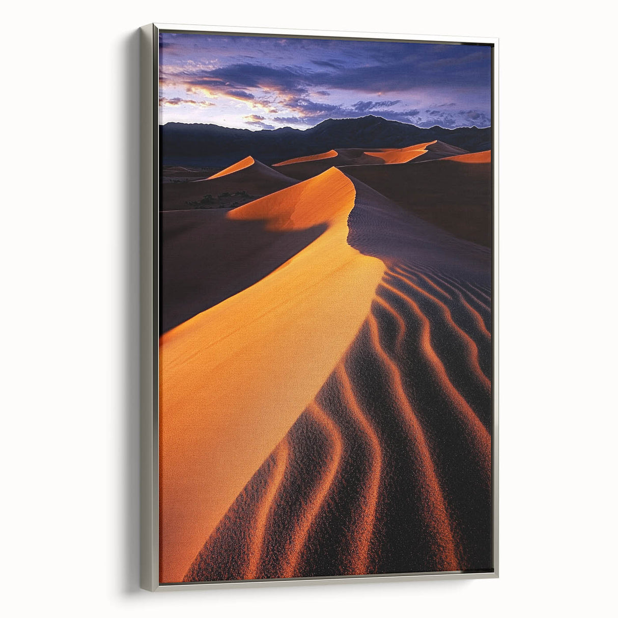 Framed canvas artwork showcasing serene sand dunes in a minimalist design, featuring a sleek silver frame. Perfect for modern decor or nature-themed interiors.