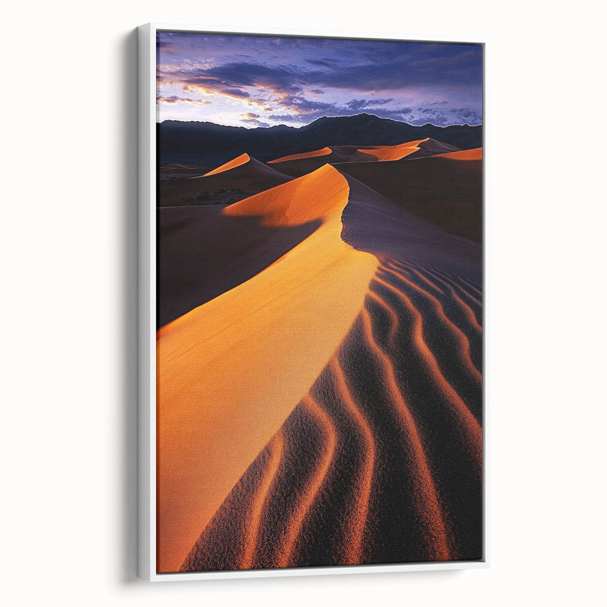 Framed canvas artwork depicting serene sand dunes in soft beige and golden hues, set against a bright white frame, perfect for enhancing modern home decor.