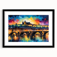 Colorful abstract art print of a European cityscape with vibrant hues, displayed in a black frame with mat.