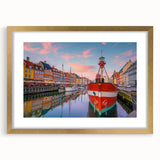 Abstract art print depicting a European scenery in muted gold and blue tones on a framed canvas.