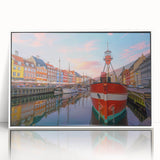 Mid-century modernist art of a serene Danish landscape in muted green and blue tones, acrylic print framed in white.