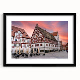 Extra large abstract art print of a colorful Bavarian scenery on textured canvas, framed in black.
