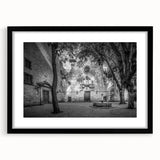 Abstract art print of colorful textured Barcelona scenery in a black frame, ideal for living room decor.