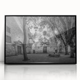 Large abstract wall art depicting a Barcelona cityscape in muted gray and blue tones on a black framed acrylic print.