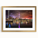Abstract art print of Auckland skyline in muted gray and blue tones on a gold-framed canvas, ideal for living room decor.
