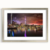 Textured abstract art print of Auckland skyline in muted blues and grays on a framed silver mat, ideal for bedroom art.
