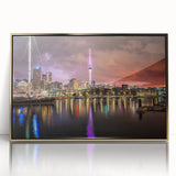 Large art print of Auckland skyline depicted in mid-century modernist style with gold frame, ideal for modern art wall decor.